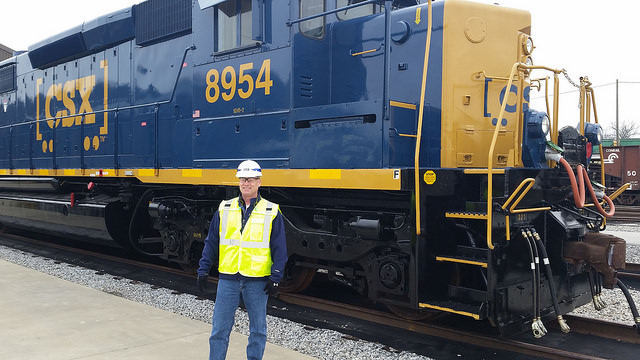 Railinc CFO Yates Parker in front of a CSX locomotive.
