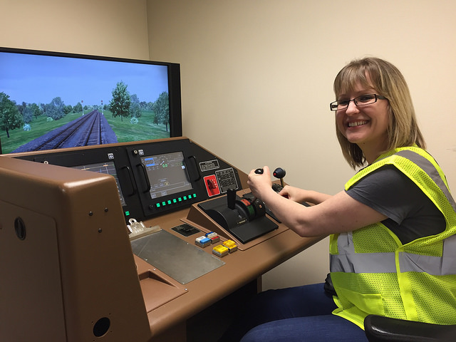 A Railinc employee tries out a locomotive simulator at CSX REDI.