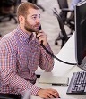 Employee on phone looking at computer